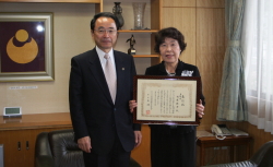 市役所を訪れ、全国大会での表彰を速水市長(左)に報告した西原倍子さん