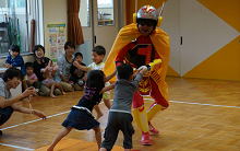 チャレンジマンと相撲をする子どもたち