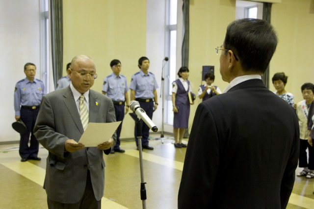 メッセージを代読する三木会長