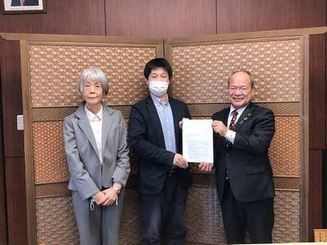石飛市長(右)に答申書を手渡す関委員長(中央)と菅原副委員長(左)